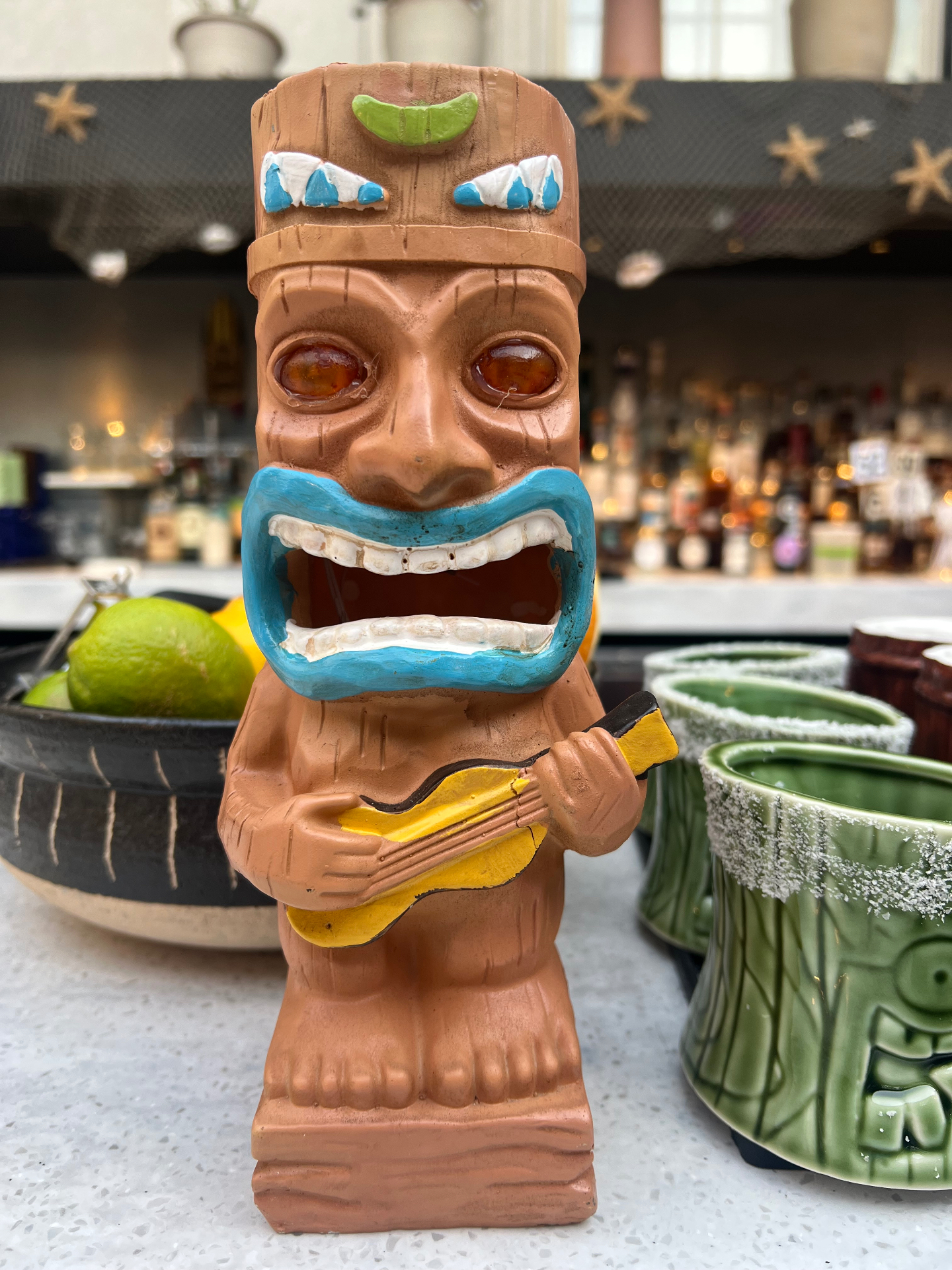A decorative tiki figurine at the courtyard bar