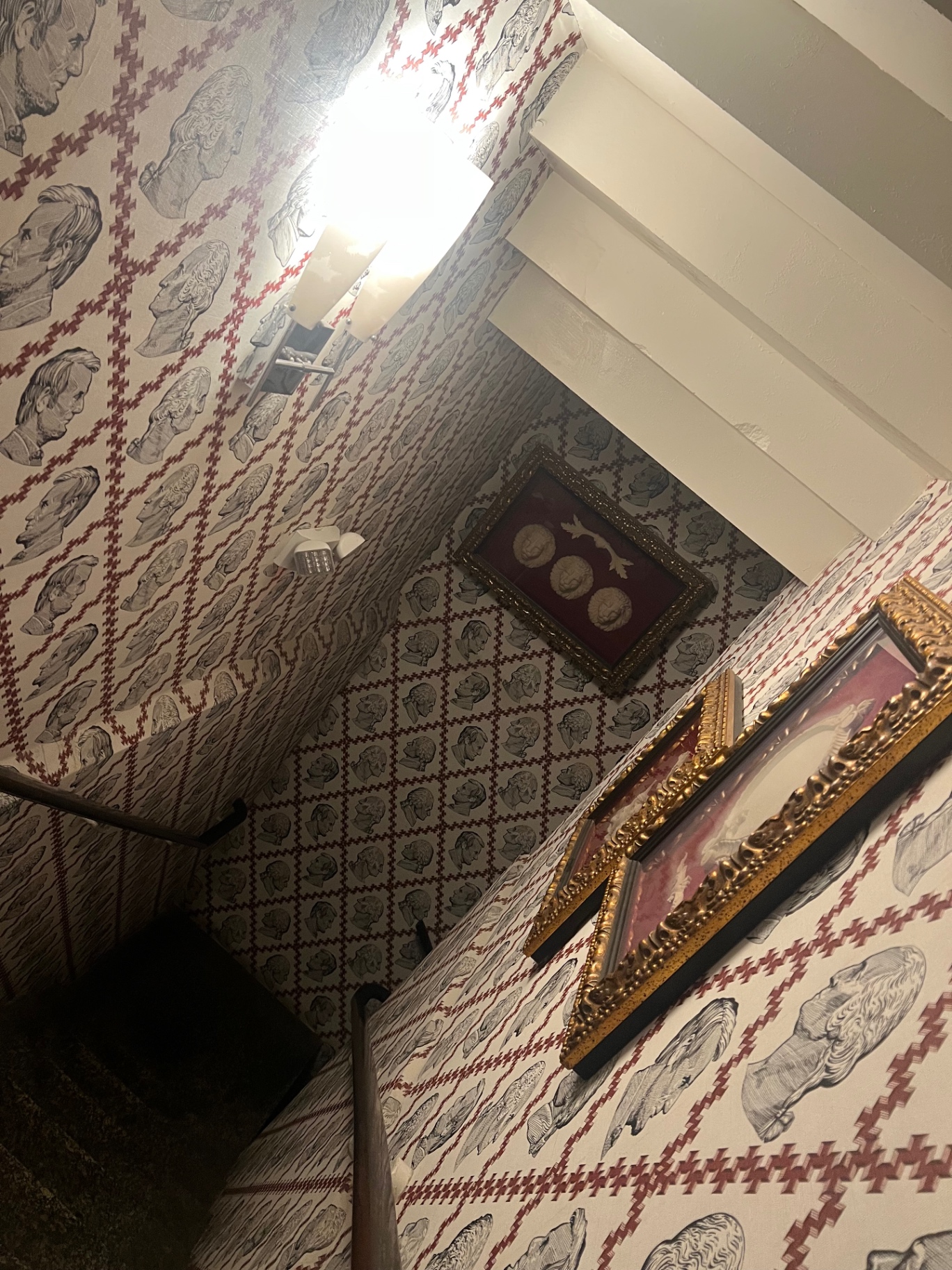 Gilt frames against the patterned walls